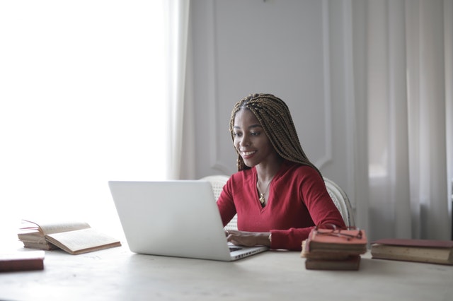 woman-in-red-long-sleeve-shirt-using-macbook-air-3786763